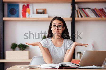 Confused woman indoors working with documents. Stock photo © deandrobot