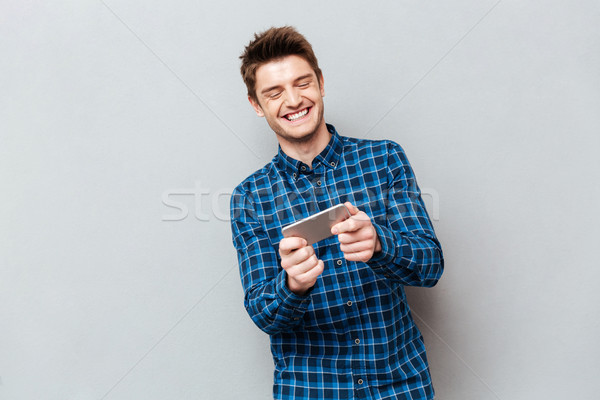 面白い 男 笑い 演奏 スマートフォン 孤立した ストックフォト © deandrobot