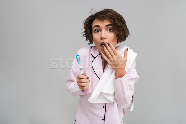 Portrait of a susrprised young girl in pajamas Stock photo © deandrobot
