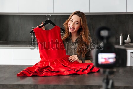 Smiling young girl recording her video blog episode Stock photo © deandrobot