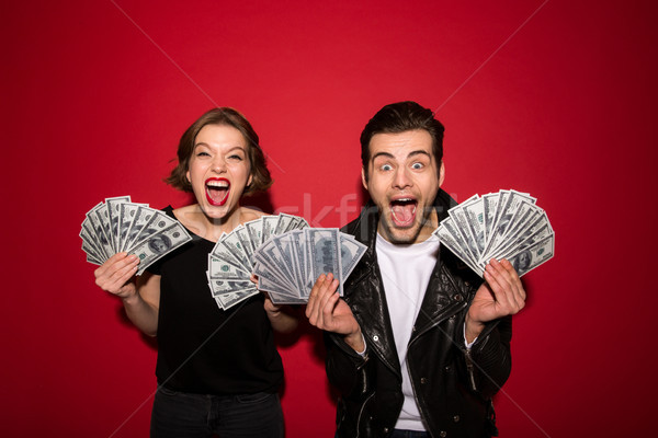 Happy screaming punk couple posing with money and rejoice Stock photo © deandrobot