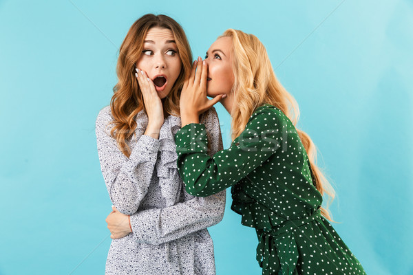 Blonde woman in dress talking something to ear Stock photo © deandrobot