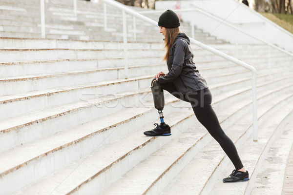 Image of disabled running girl with prosthetic leg in sportswear Stock photo © deandrobot