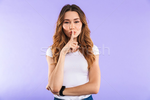 Woman isolated over purple wall background showing silence gesture. Stock photo © deandrobot