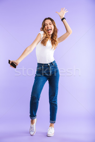 Full length portrait of an energetic young girl Stock photo © deandrobot