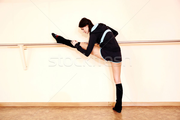 Young fit woman stretching at gym Stock photo © deandrobot