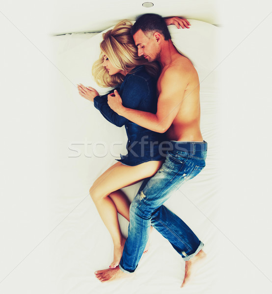 Top view of a couple sleeping together on the bed Stock photo © deandrobot