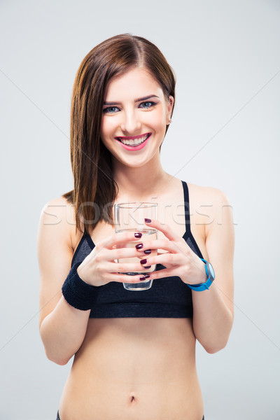 Mosolyog sportos nő tart üveg víz Stock fotó © deandrobot