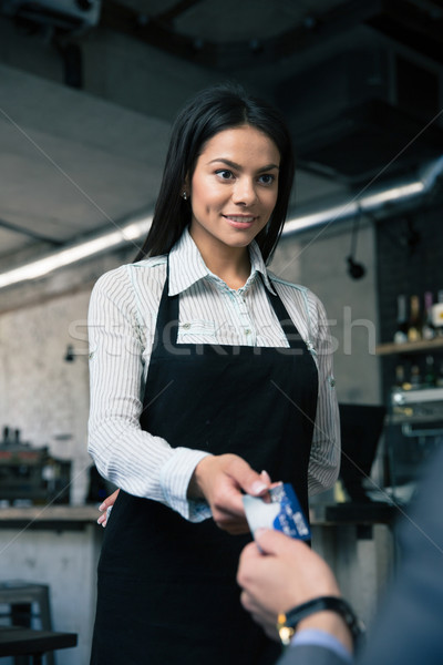 Man giving bank card to female waiter Stock photo © deandrobot