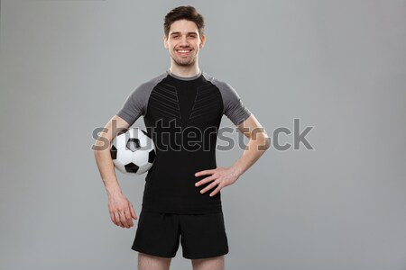 Soccer player holding ball Stock photo © deandrobot