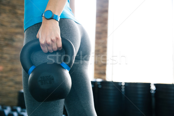 Woman working out with kettle ball Stock photo © deandrobot