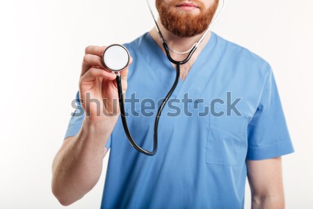 Closeup portrait of a male doctor using stethoscope  Stock photo © deandrobot