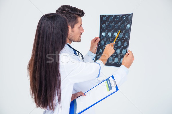 Two doctors looking at x-ray picture of brain  Stock photo © deandrobot