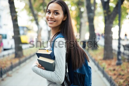 Female student looking back at camera  Stock photo © deandrobot
