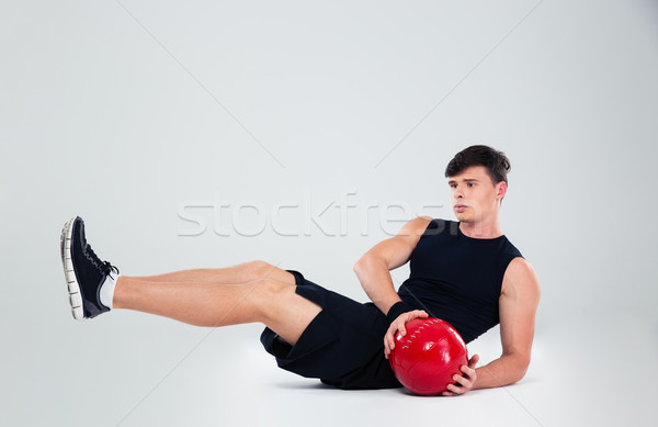 Portrait of athletic man workout with fitness ball Stock photo © deandrobot