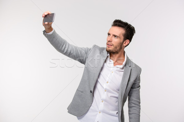 Happy businessman making selfie photo Stock photo © deandrobot
