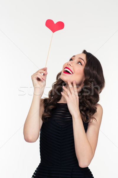Portrait of cheerful retro styled young woman with heart booth  Stock photo © deandrobot