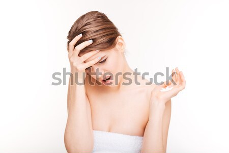 Woman with headache holding pills Stock photo © deandrobot
