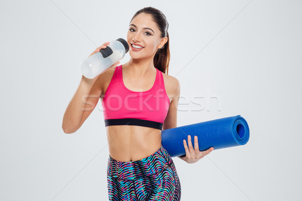 Gelukkig vrouw yogamat drinkwater geïsoleerd Stockfoto © deandrobot