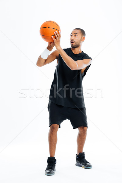 Stock photo: Full length portrait of a concentrated african man playing basketball