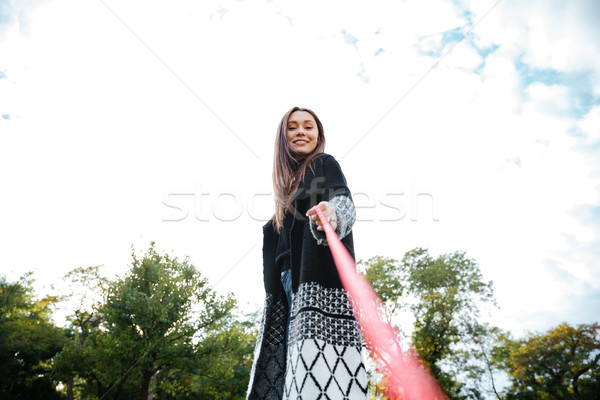 Cheerful woman holding dog on leash and walking in park Stock photo © deandrobot