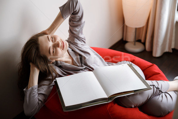 Woman lying on bag chair with closed eyes Stock photo © deandrobot