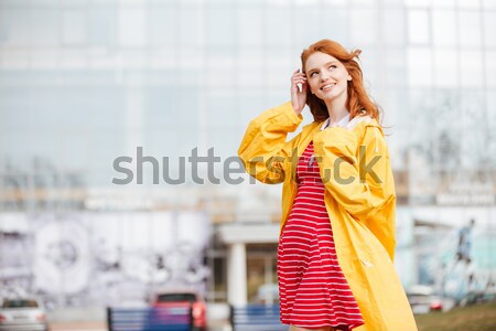 Portrait of a friendly pretty ginger hair girl in coat Stock photo © deandrobot