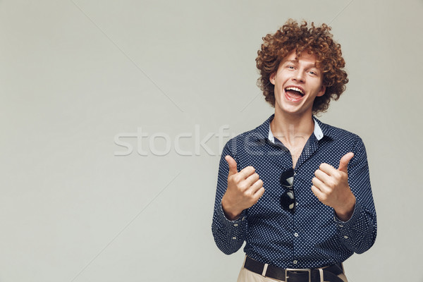 Happy retro man showing thumbs up. Stock photo © deandrobot