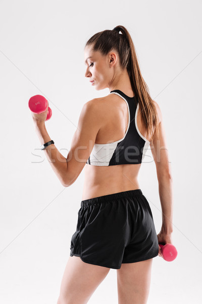 Back view portrait of a confident sportswoman standing Stock photo © deandrobot