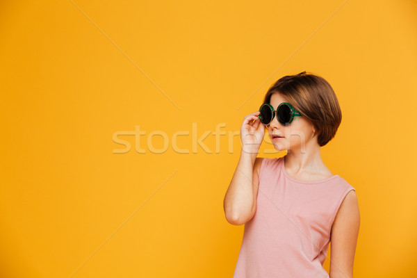 Confident serious girl in sunglasses looking aside Stock photo © deandrobot