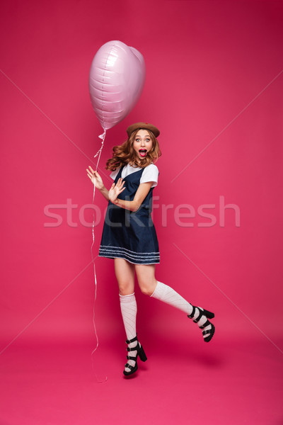 Surprised happy lady with air balloon jumping and looking camera Stock photo © deandrobot