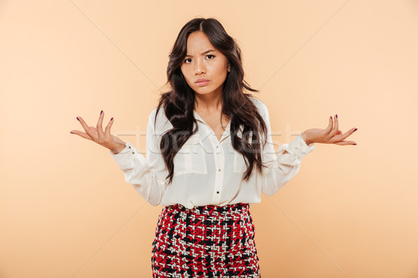 Portrait of a confused asian woman Stock photo © deandrobot