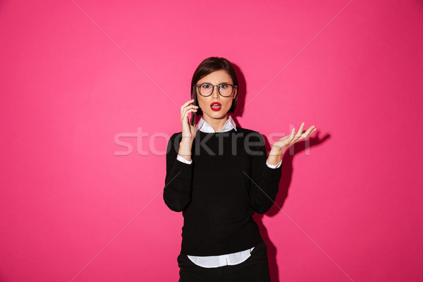 недовольный молодые Lady говорить смартфон изолированный Сток-фото © deandrobot
