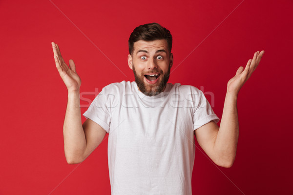 Shocked young handsome man. Looking camera. Stock photo © deandrobot