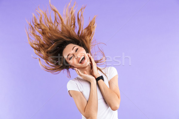 Portrait a cheerful young girl shaking her long hair Stock photo © deandrobot