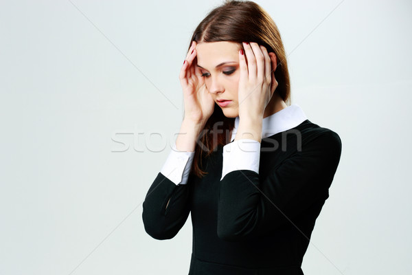 Portrait of a young woman touching her head with headache Stock photo © deandrobot