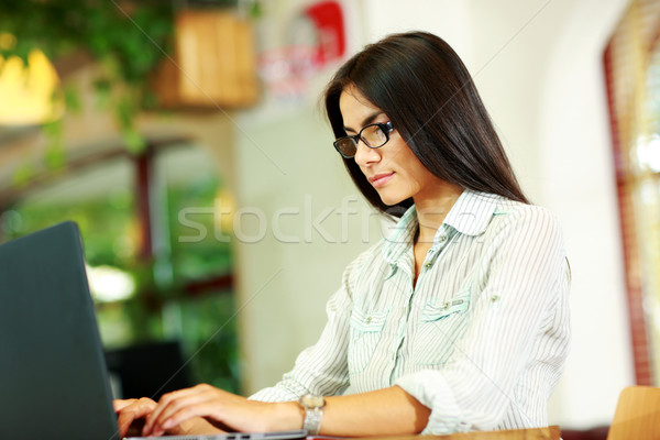Portrait of concetrated businesswoman working at office Stock photo © deandrobot