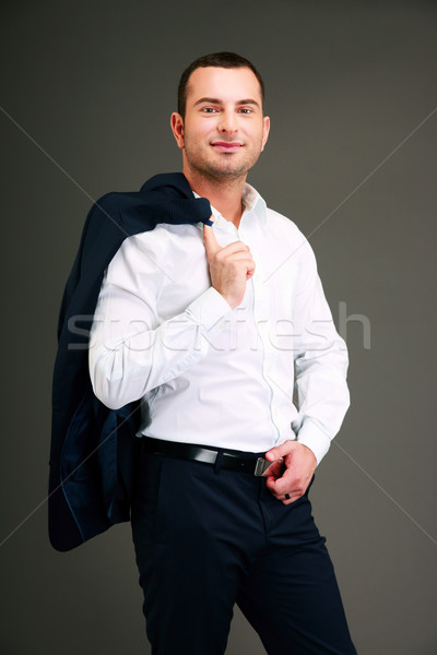 Portrait of a businessman holding his jacket over shoulder Stock photo © deandrobot