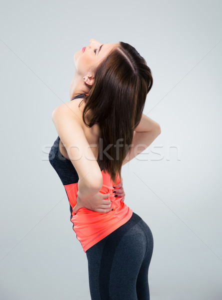 Sports woman having back pain Stock photo © deandrobot
