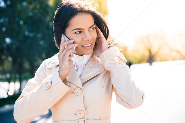Smiling woman talking on the phone Stock photo © deandrobot