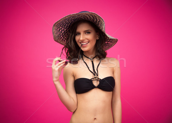 Happy young woman in swimsuit with hat and sunglasses Stock photo © deandrobot