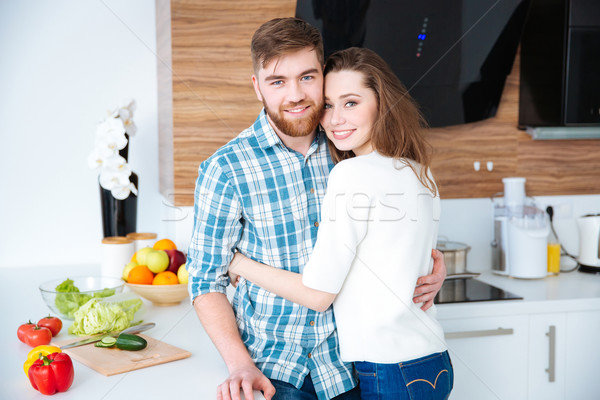 Belo casal cozinha em pé casa Foto stock © deandrobot