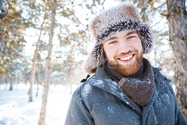 Happy man standing in winter park Stock photo © deandrobot