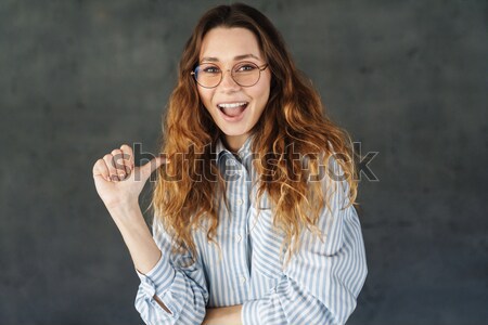 Surprised excited beautiful young woman in black dress Stock photo © deandrobot