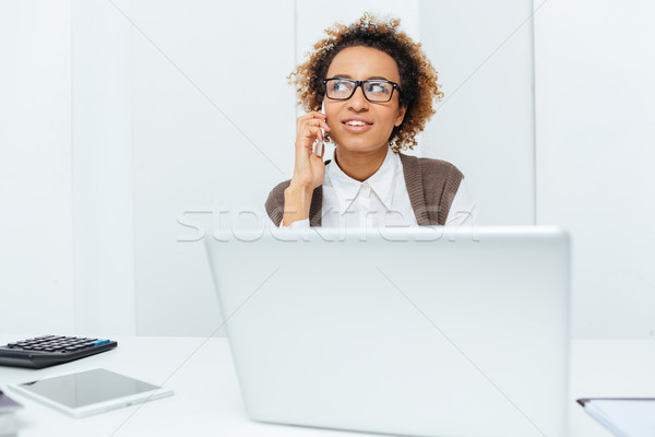 Stock photo: Smiling african american woman accountant talking on cell phone 