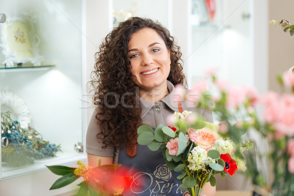 Cheerful woman florist at work in flower shop Stock photo © deandrobot