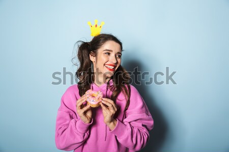 Happy pretty pinup girl eating and kissing yellow lollipop Stock photo © deandrobot
