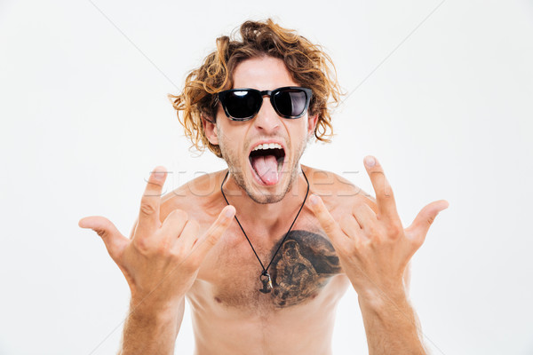 男子 墨鏡 顯示 舌頭 岩 手勢 商業照片 © deandrobot
