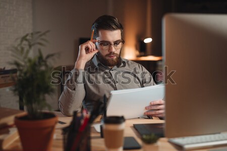 Concentrated bearded designer working and drawing sketches in album. Stock photo © deandrobot