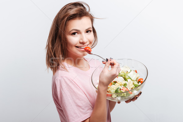 Vonzó fiatal hölgy eszik saláta fotó Stock fotó © deandrobot